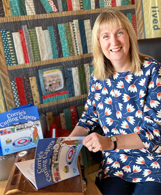 Alison Page with her book Corrie's Capers in the library.